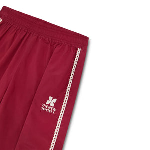 The New Society - Pantalón deportivo con logo de encaje TNS | Rojo