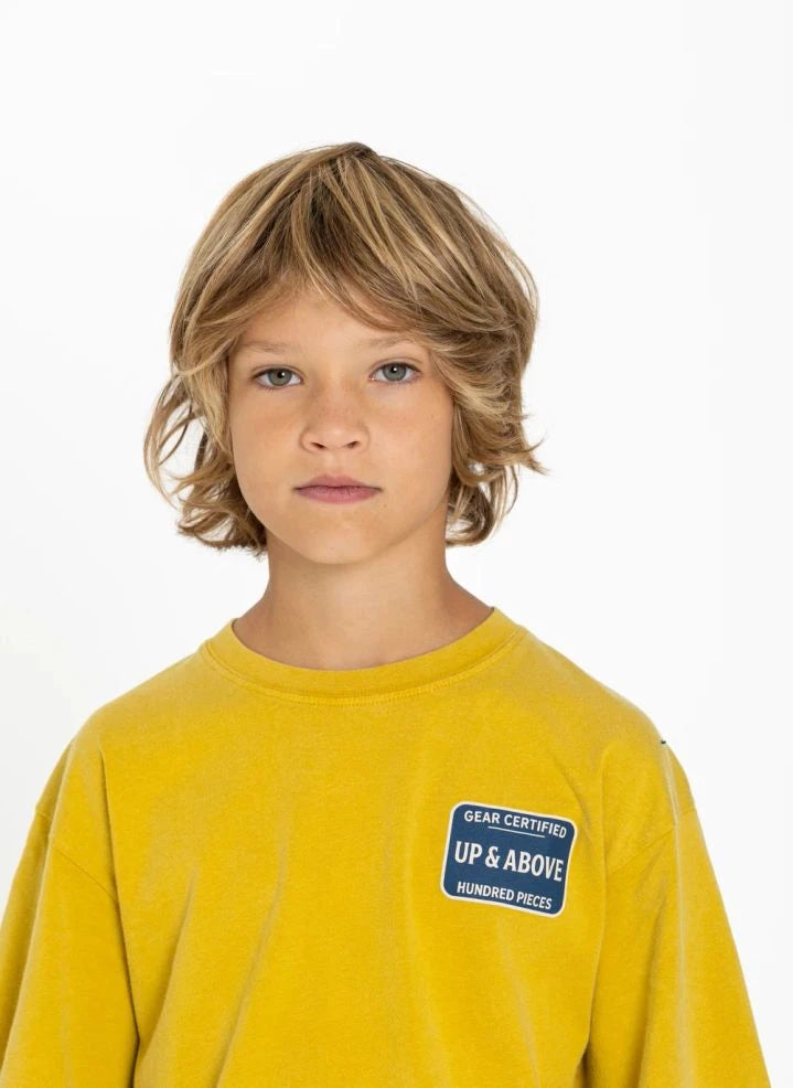 Hundred Pieces - Camiseta de Algodón Orgánico Certificada por Finn | Mostaza