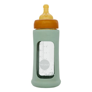 Hevea - Biberón de vidrio de boca ancha con flujo medio y funda protectora | Verde almendra